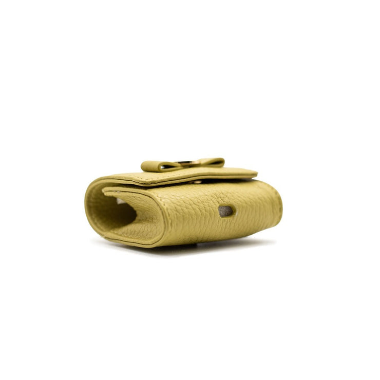 Swatzell + Heilig's AirPod Case in color Soft Olive, picture showing the hole in the bottom of the item ideal for airpods.