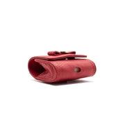 Swatzell + Heilig's AirPod Case in color red poppy, picture showing the hole in the bottom of the item ideal for airpods.