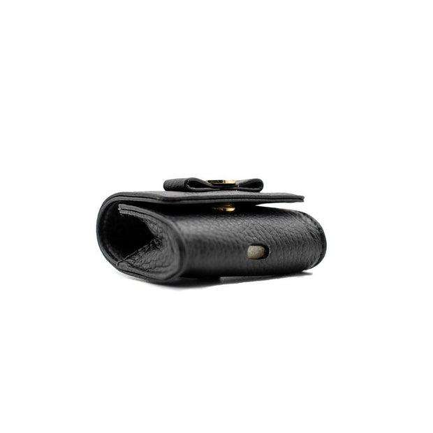 Swatzell + Heilig's AirPod Case in color black, picture showing the hole in the bottom of the item ideal for airpods.
