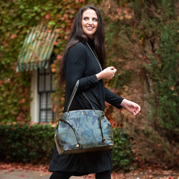 Swatzell + Heilig's Highland Bag in color Camo, picture showing the bag with a model who is wearing it on her arm