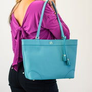 Swatzell + Heilig's Charleston Bag in color Blue, picture showing the bag with a model who is wearing it on her shoulder